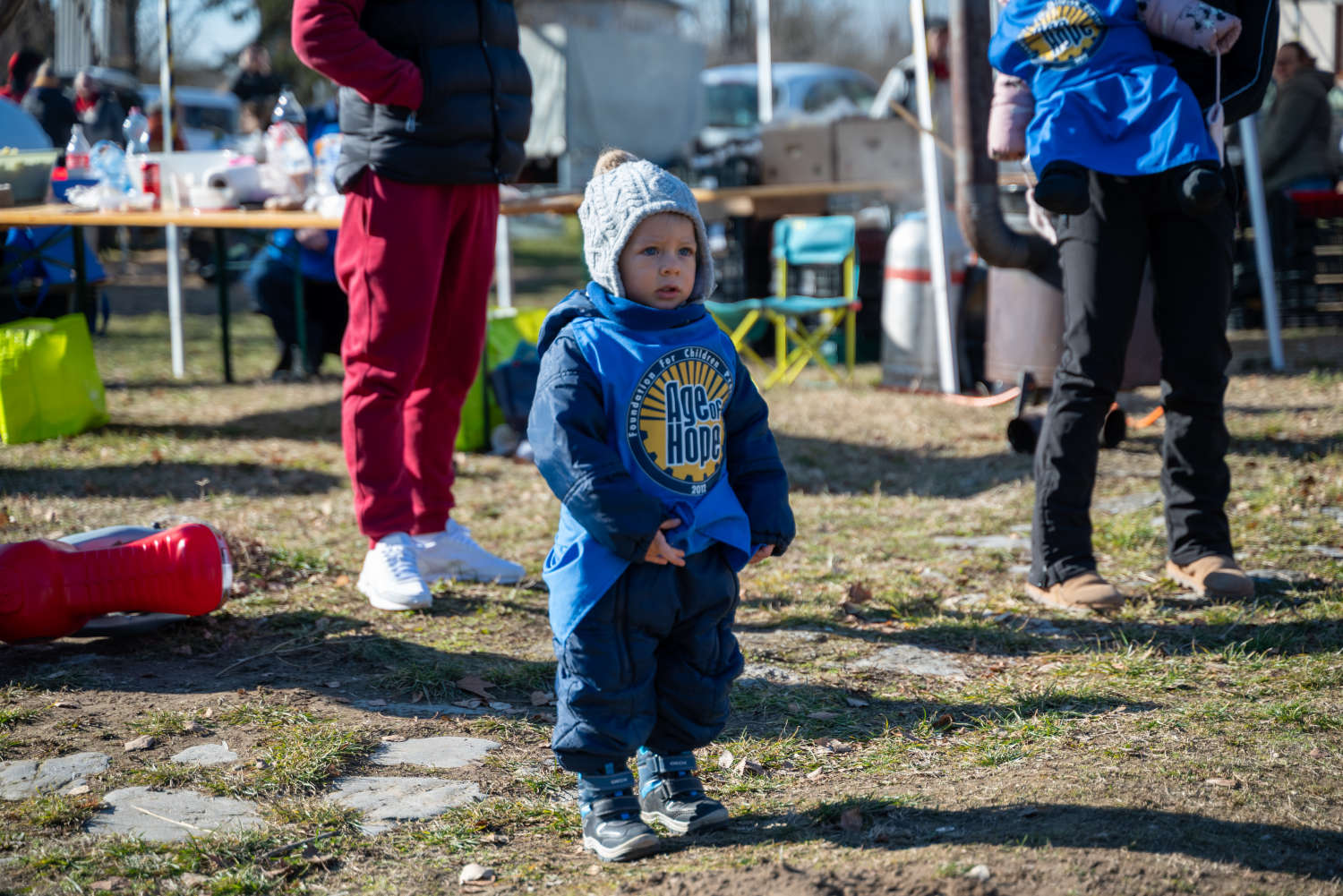 Small child standing at the outdoor community cooking site