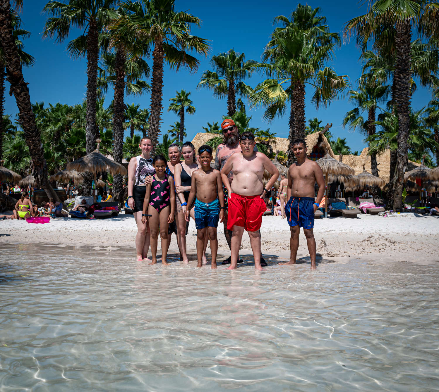 Group photo under the palm trees on the beach